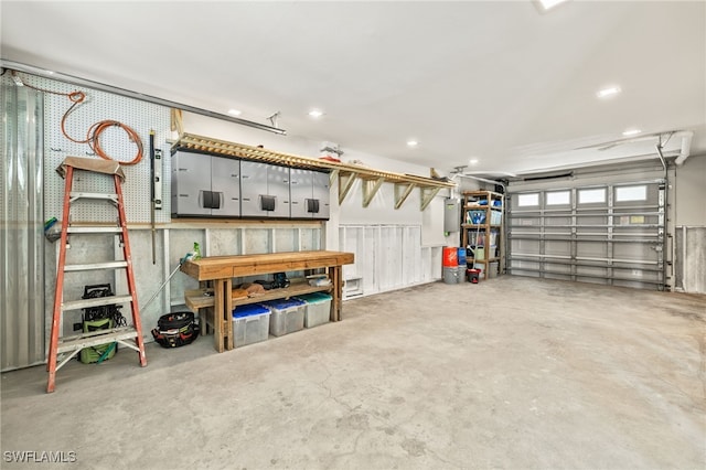 garage with electric panel and recessed lighting