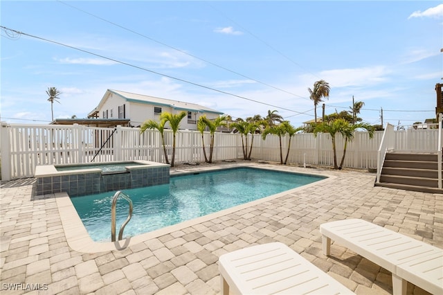 view of swimming pool with a patio, a fenced backyard, and a pool with connected hot tub