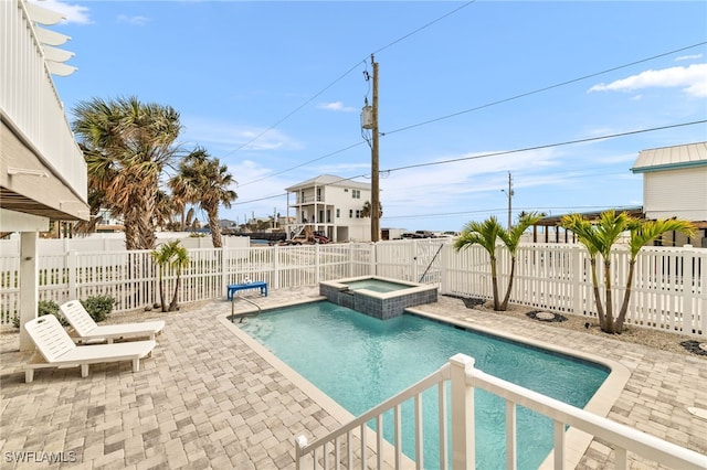 view of pool with a patio area, a fenced backyard, and a pool with connected hot tub