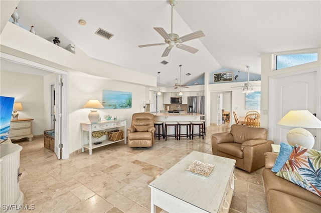 living room with visible vents, lofted ceiling, and ceiling fan