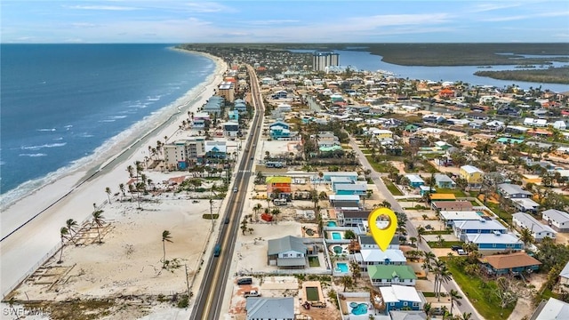 drone / aerial view featuring a water view and a beach view