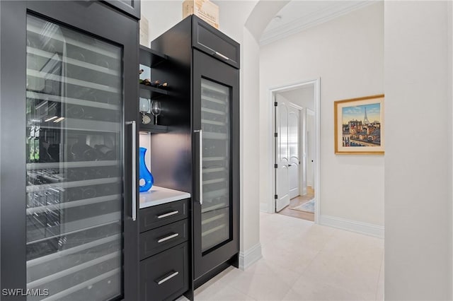 interior space featuring ornamental molding, wine cooler, and baseboards