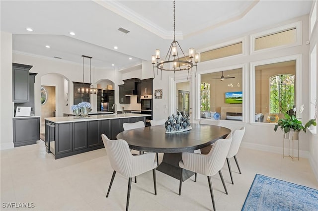 dining space featuring ornamental molding, visible vents, arched walkways, and a chandelier