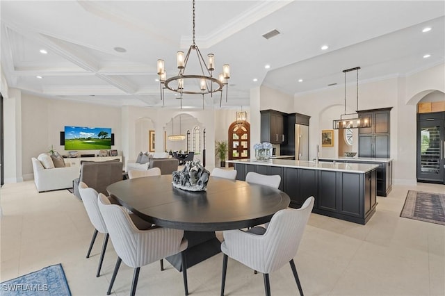 dining room with arched walkways, an inviting chandelier, visible vents, and crown molding