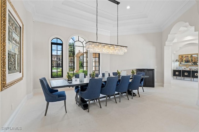 tiled dining space featuring a tray ceiling, recessed lighting, a high ceiling, ornamental molding, and baseboards