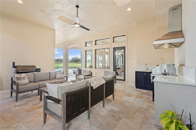 view of patio / terrace featuring outdoor lounge area, a sink, area for grilling, and ceiling fan