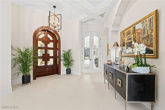 foyer entrance featuring arched walkways, coffered ceiling, baseboards, french doors, and ornamental molding