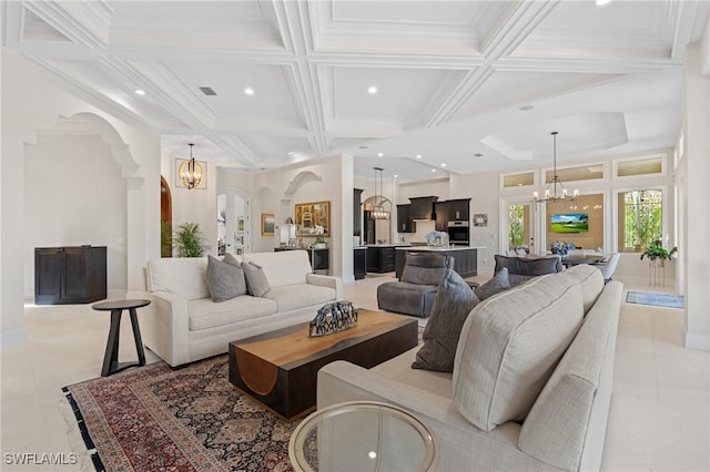 living area featuring a chandelier, arched walkways, coffered ceiling, and beamed ceiling