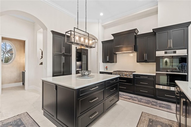 kitchen featuring arched walkways, a kitchen island, ornamental molding, custom exhaust hood, and stainless steel appliances