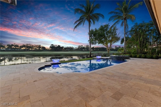 view of swimming pool featuring a patio, a water view, fence, and a pool with connected hot tub