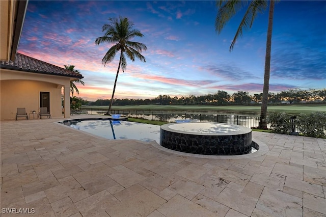 view of swimming pool featuring a fenced in pool, a water view, a patio, and fence