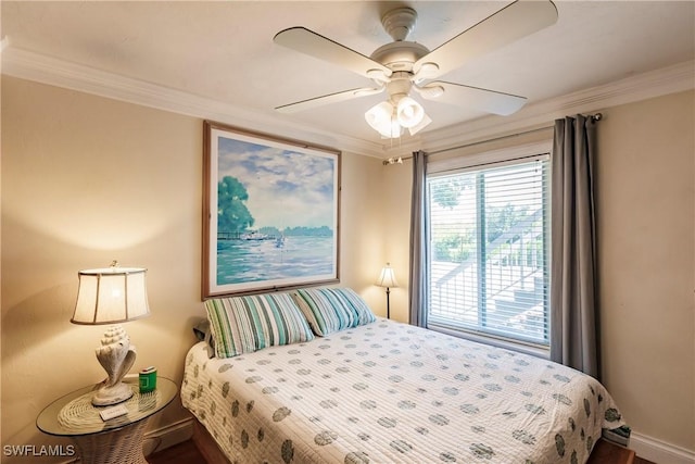 bedroom with ceiling fan, ornamental molding, and baseboards