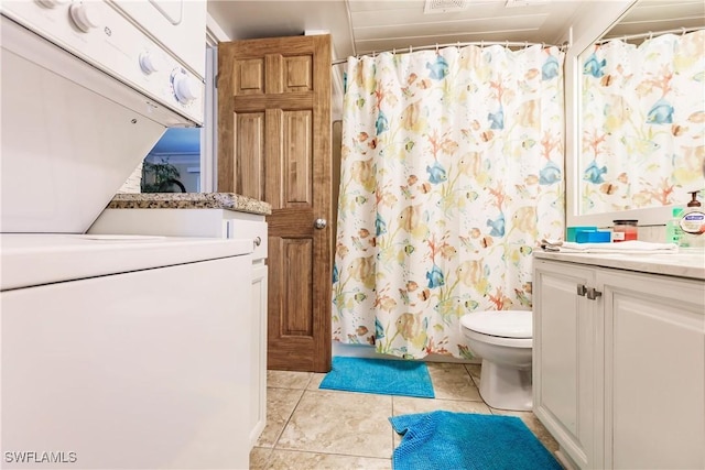 bathroom featuring toilet, a shower with curtain, tile patterned flooring, vanity, and stacked washing maching and dryer