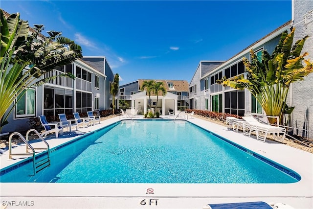 community pool with a patio area and a residential view