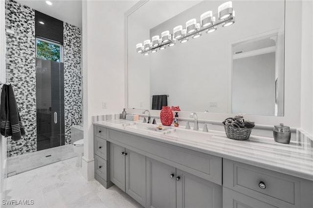 bathroom with toilet, a sink, marble finish floor, a shower stall, and double vanity