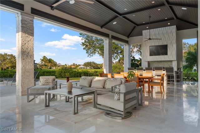 view of patio with outdoor dining space, ceiling fan, and an outdoor hangout area