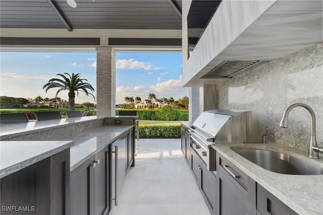 view of patio / terrace featuring exterior kitchen and a sink