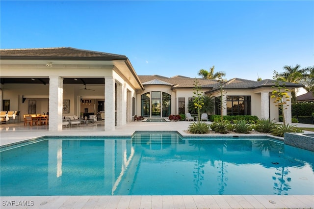 pool featuring an outdoor living space, a ceiling fan, and a patio