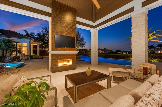 view of patio featuring an outdoor living space with a fireplace and an outdoor pool