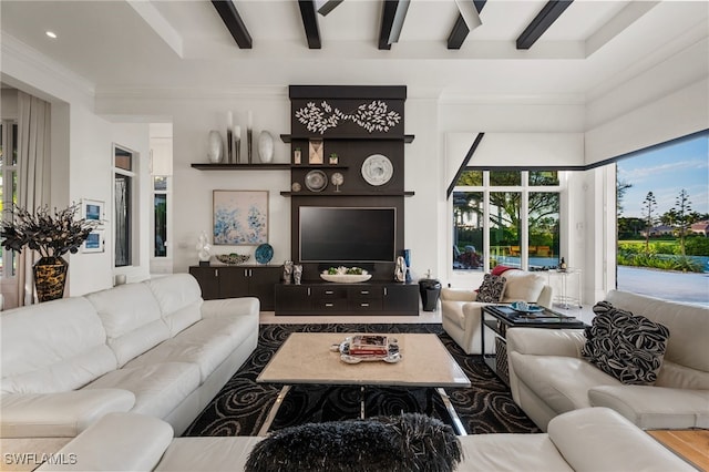 living area featuring ornamental molding and beam ceiling