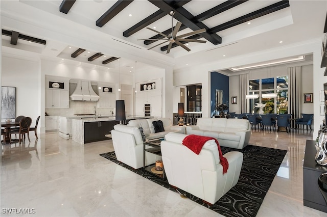 living room with marble finish floor, a towering ceiling, ceiling fan, coffered ceiling, and beamed ceiling