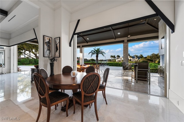 dining area with marble finish floor and ornamental molding