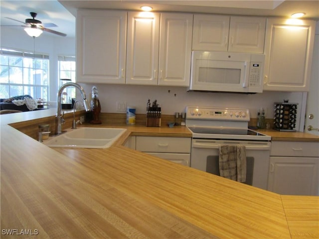 620 Mirror Lakes Falls Ct, Lehigh Acres, FL 33974 - kitchen featuring white appliances, white cabinets, a sink, and light countertops