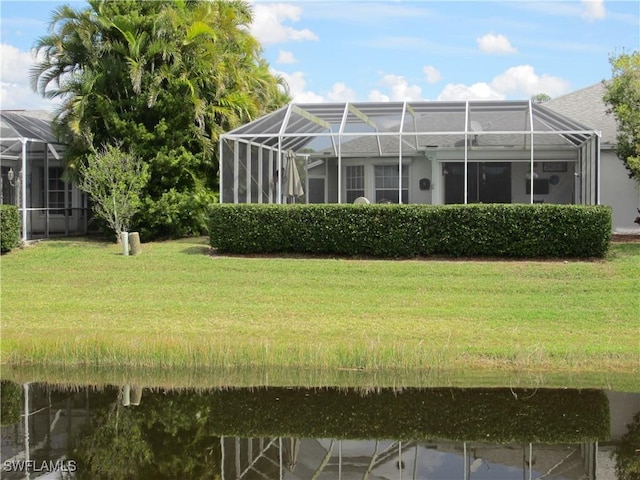 620 Mirror Lakes Falls Ct, Lehigh Acres, FL 33974 - view of yard with glass enclosure and a water view