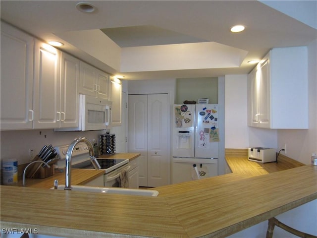 620 Mirror Lakes Falls Ct, Lehigh Acres, FL 33974 - kitchen featuring white appliances, white cabinetry, a sink, and recessed lighting