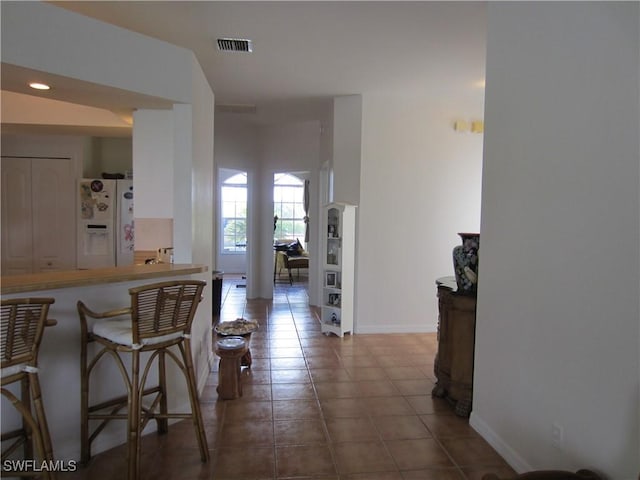 620 Mirror Lakes Falls Ct, Lehigh Acres, FL 33974 - hall with tile patterned flooring, visible vents, and baseboards