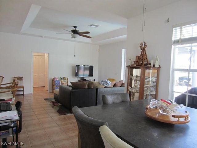 620 Mirror Lakes Falls Ct, Lehigh Acres, FL 33974 - dining area with light tile patterned floors, a tray ceiling, visible vents, and a ceiling fan
