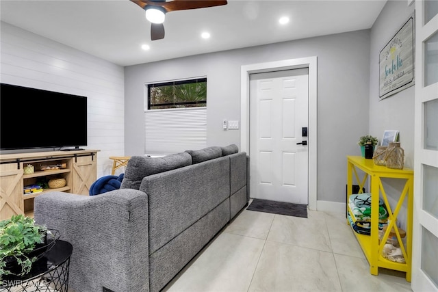 living room with ceiling fan, wooden walls, and recessed lighting