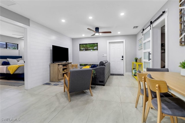 living area featuring recessed lighting, visible vents, a barn door, a ceiling fan, and light tile patterned flooring