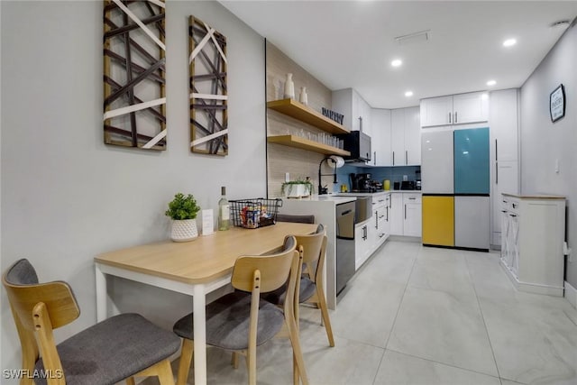 kitchen featuring white cabinetry, decorative backsplash, open shelves, and stainless steel dishwasher