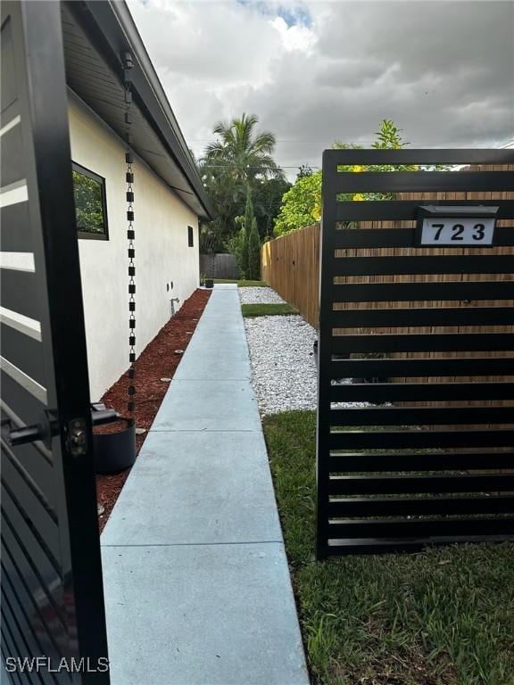 view of side of property featuring fence and stucco siding