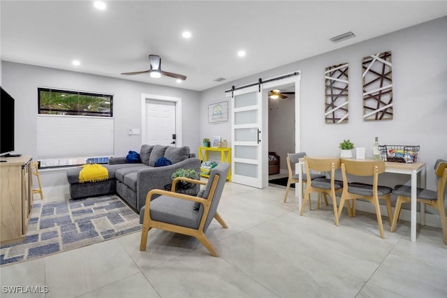 living area featuring a barn door, visible vents, ceiling fan, and recessed lighting