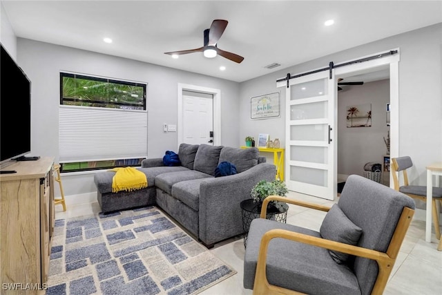 living room with a barn door, visible vents, baseboards, ceiling fan, and recessed lighting