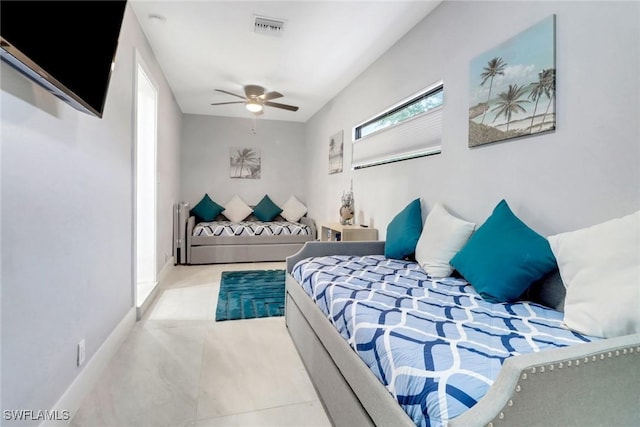 bedroom featuring a ceiling fan, visible vents, and baseboards