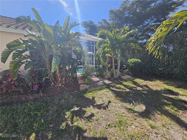 view of yard featuring glass enclosure