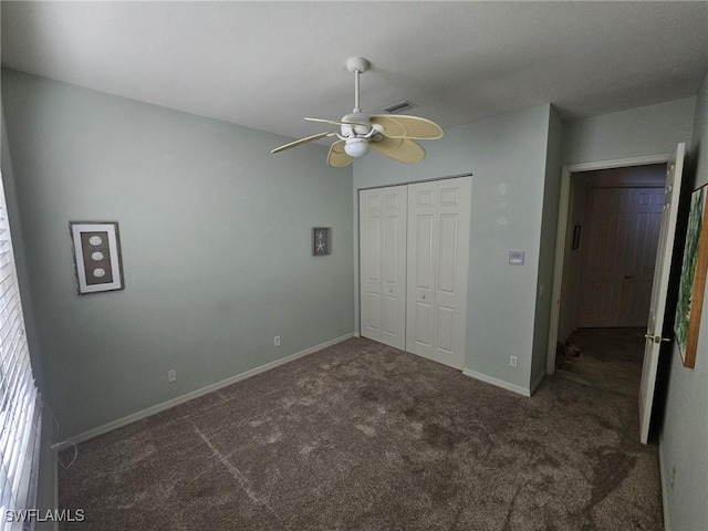 unfurnished bedroom featuring carpet, a closet, visible vents, a ceiling fan, and baseboards