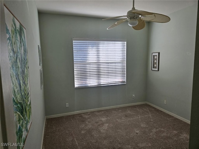 empty room featuring carpet floors, a ceiling fan, and baseboards