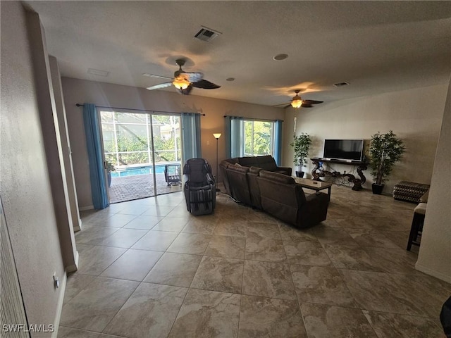 living area with visible vents and a ceiling fan