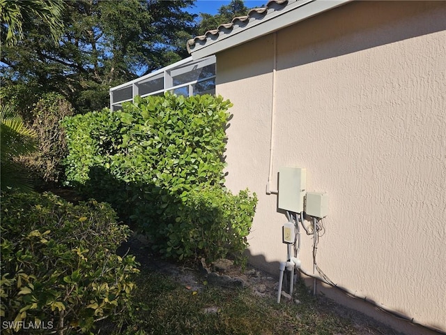 view of property exterior featuring a tiled roof and stucco siding