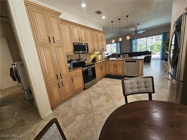 kitchen featuring tasteful backsplash, visible vents, a peninsula, stainless steel appliances, and a sink