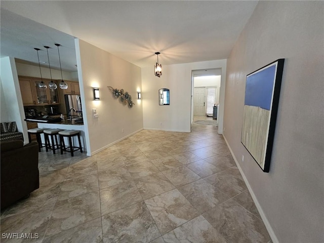 interior space with a notable chandelier and baseboards