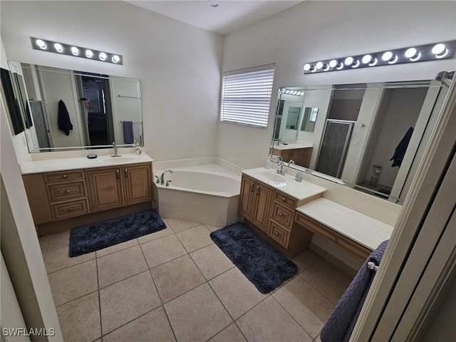 full bath with a sink, two vanities, a shower stall, a bath, and tile patterned floors