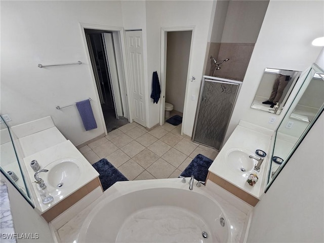 bathroom featuring toilet, a stall shower, a garden tub, and vanity