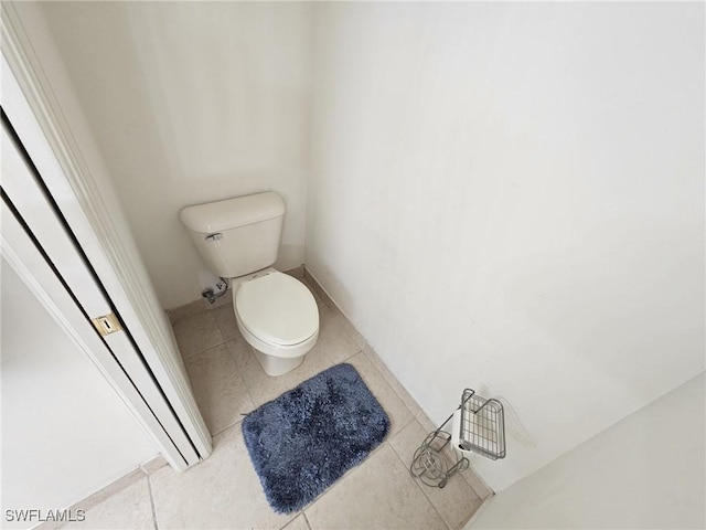 bathroom featuring toilet and tile patterned flooring