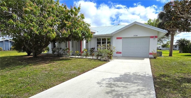 ranch-style home with stucco siding, an attached garage, a front yard, metal roof, and driveway