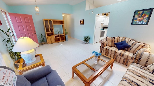 living area with lofted ceiling and tile patterned flooring